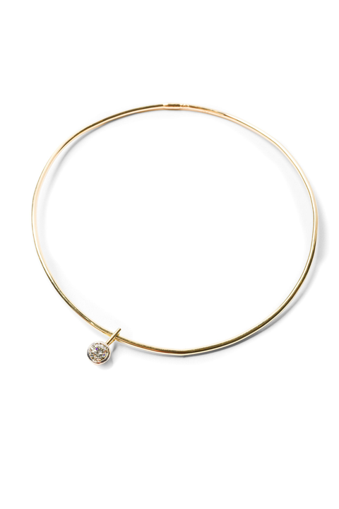 Gold collar necklace with a small round diamond pendant on a white background