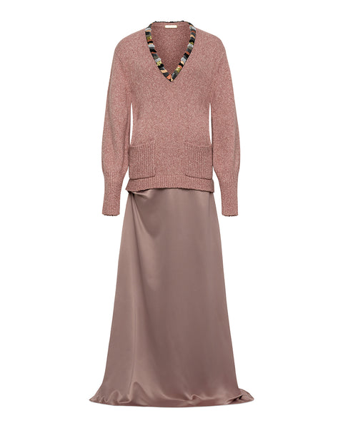 Pink knitted top and satin skirt dress with embroidery on the v-neck line on a white background