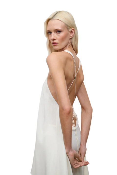 Woman wearing a white dress with thin straps close-up angle