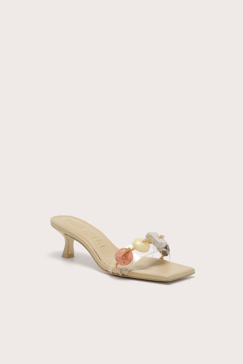 A slip on kitten heel that features multicolored stones across the toe strap. 