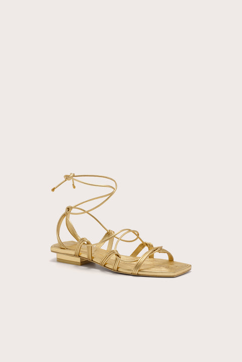 A metallic gold gladiator sandal with a slim heel.