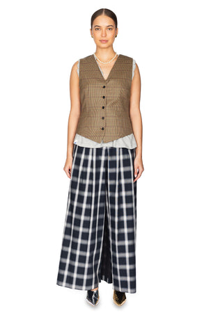 Woman wears blue plaid skort pants with plaid vest.