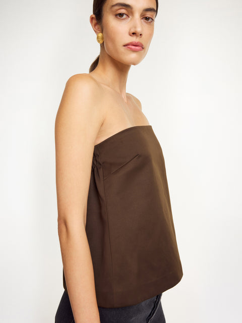 Side view of woman in the brown strapless top.