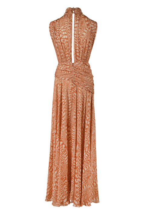A sleeveless halter-neck maxi dress with a textured, abstract pattern in terracotta orange and beige, featuring a draped wrap-style waist and a split back neckline.