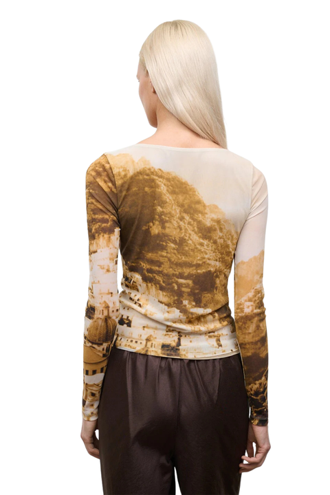 Person wearing a long-sleeve top with a unique design on a white background