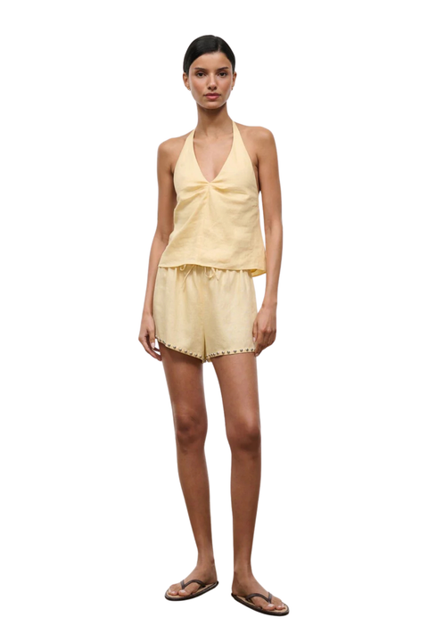 Woman wearing a yellow outfit on a white background