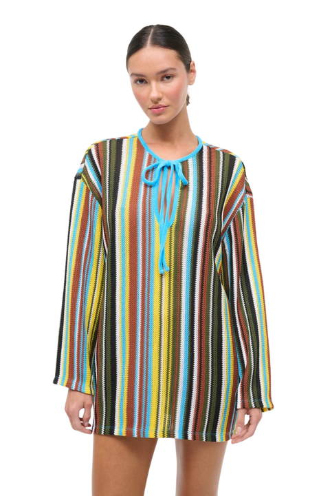 Woman wearing a colorful striped crochet dress on a white background close up blue neckline