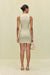 Back view of a woman wearing a khaki high-neck mini dress that features a utility design, front zipper, and sleek side pockets, paired with black sandals.  