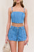 Up close look at a woman wearing a blue denim corset with matching cargo denim shorts. 