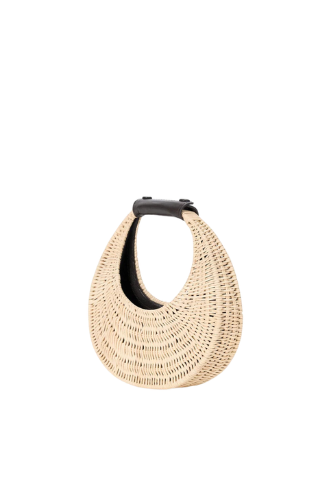 Woven beige round mini bag with a brown strap on a white background side angle