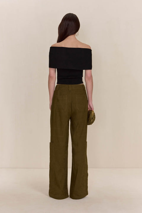 Back view of a woman wearing olive green cargo pants paired with a black off-the-shoulder top. 