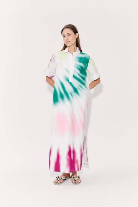 Woman poses in tie-dye maxi dress with collar and cuffed short sleeves.