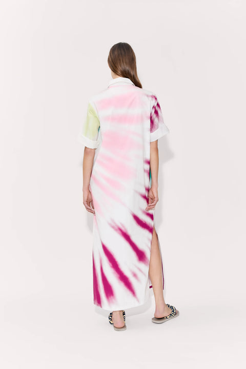 Woman showing back of tie-dye midi dress with side slit.