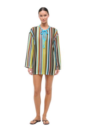 Woman wearing a colorful striped crochet dress on a white background