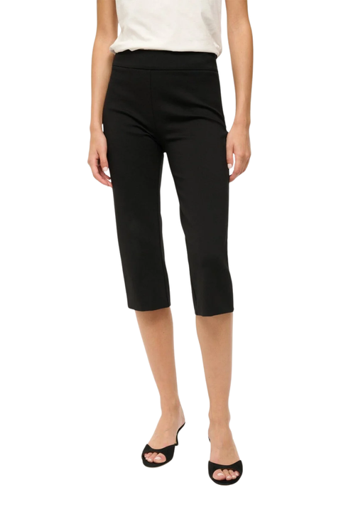 A model wearing black capri pants, paired with a cream sleeveless top and black slide sandals, shown against a plain white background.