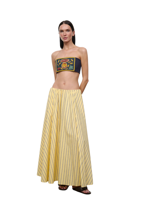 Woman wearing a yellow striped maxi skirt on a white background