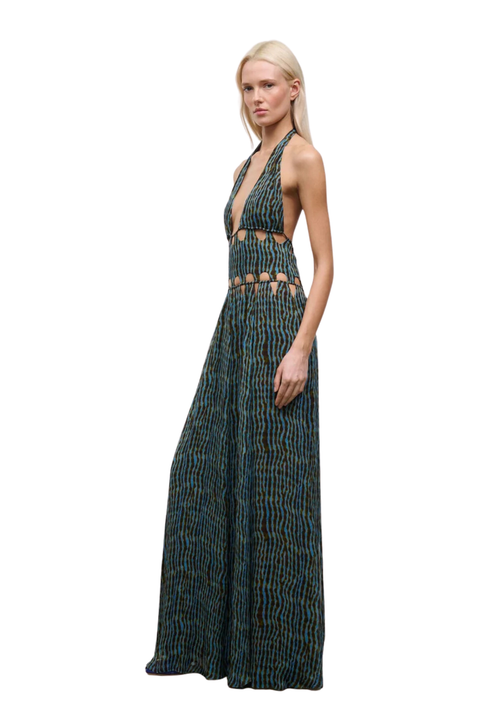 Woman wearing a blue and brown patterned halter neck maxi dress with cutouts