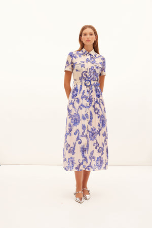 Model styled wearing the blue floral bartley utility gown with belt.