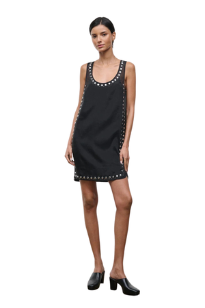 Woman wearing a black sleeveless mini dress with studs on a white background front angle