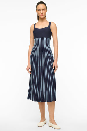 Woman wearing a navy and light blue striped knit midi dress. 