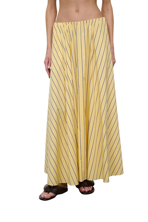 Woman wearing a yellow striped maxi skirt on a white background tilted angle