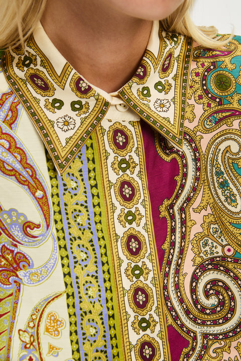 Detail shot of a woman wearing a multicolor, printed, mini shirtdress that features a point collar. 