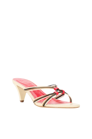 A single women's heeled sandal with a beige platform sole and a slim conical heel, featuring metallic gold and black straps with a small red bow detail on the instep, set against a plain white background.