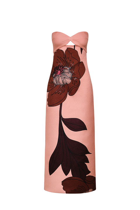 A strapless maxi dress in a dusty pink color, featuring a large dark brown floral graphic print on the front and a knotted neckline.