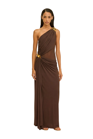 Woman wearing a brown one-shoulder maxi dress with gold hardware on a white background