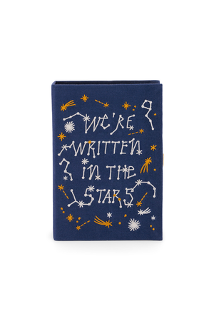 A navy bluebook clutch with white and yellow embroidered celestial designs and the text 'WE'RE WRITTEN IN THE STARS' on the front cover, shown against a plain white background.