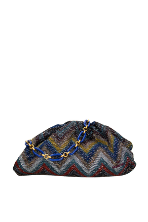 Multicolored zigzag patterned clutch bag with a chain detail on a white background