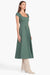 Model turned towards the right in the green short sleeve midi dress