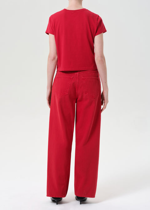 Back of person wearing red wide leg jeans and red short sleeve t-shirt on a white background