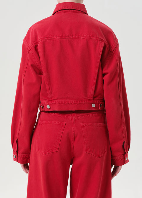 Red denim jacket and pants worn by a person on a white background