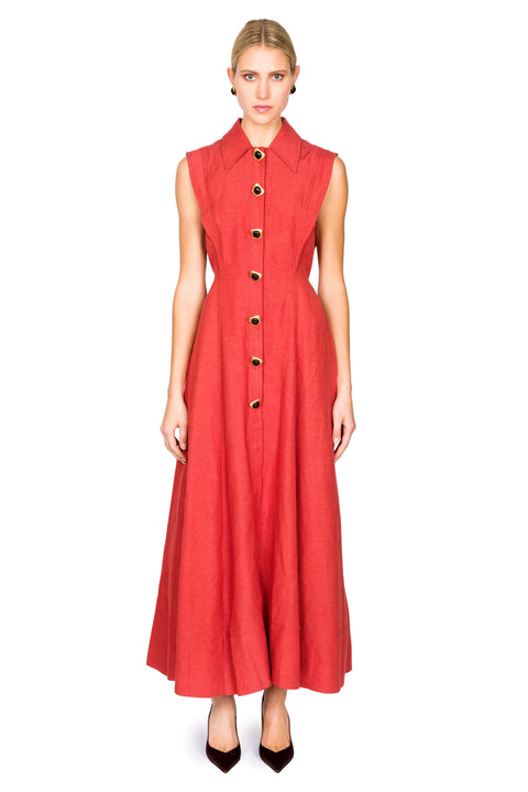 Woman wearing a red sleeveless maxi dress with large buttons on a white background facing forward