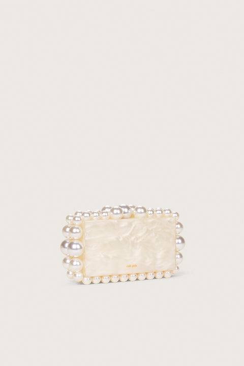 Side view of a white marbled acrylic, rectangular clutch with matching beads in graduating size lining the clutch. 