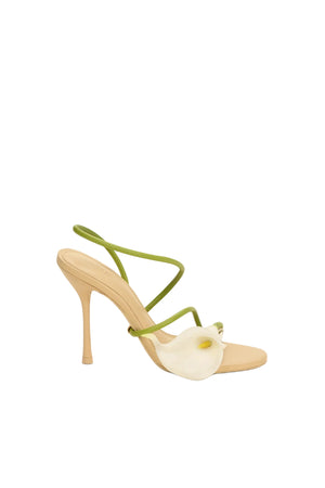 High-heeled shoe with lily and green strap on a white background