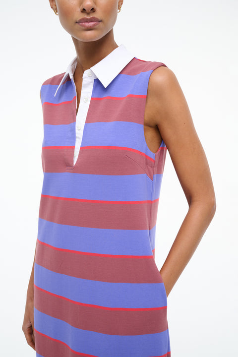 Woman wearing a sleeveless dress with red and blue horizontal stripes on a white background