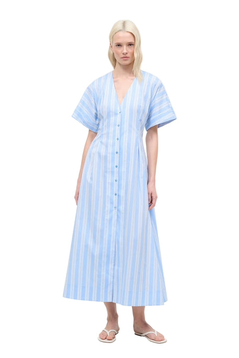 Woman wearing a light blue striped dress on a white background