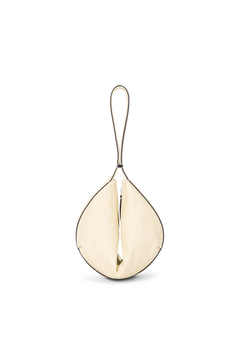 A cream shoulder bag folded together with a buckle. 