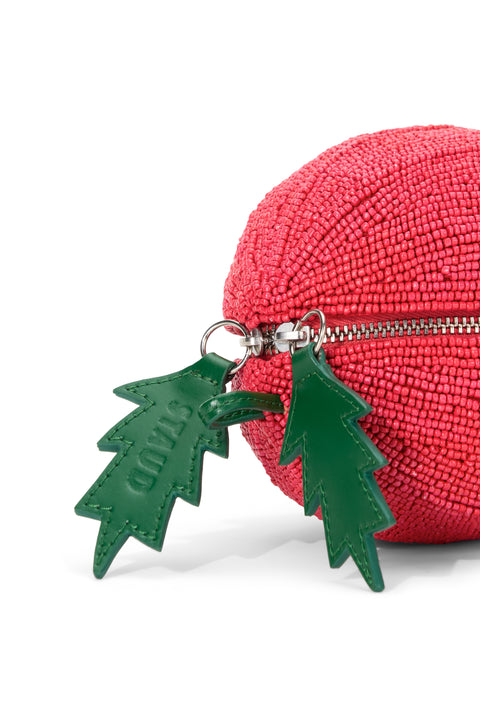 Detail shot of a beaded tomato bag with a green leather lead zipper detail. 