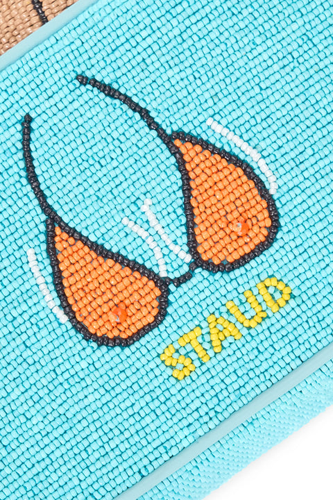 Close-up of a turquoise pouch with orange bikini design and 'STAUD' branding.
