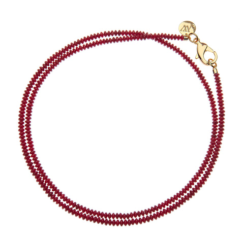 Red beaded double wrap necklace that features a large gold lobster claw clasp. 