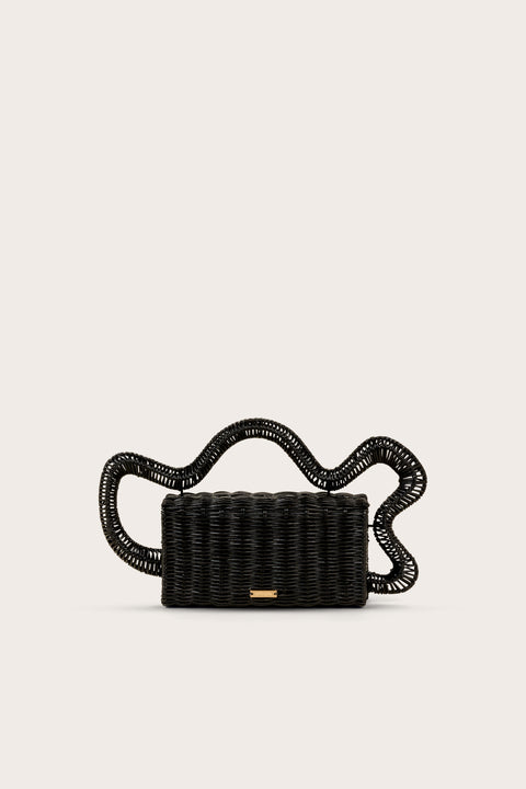 A black, rectangular rattan clutch that features an abstract wave top handle. 