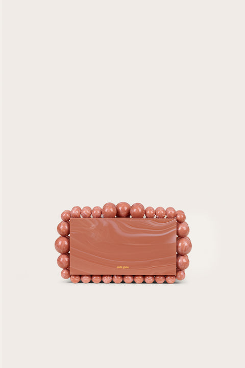 A marbled peach acrylic clutch in a rectangular design tat featur5es matching acrylic beads in graduating size along the border of the clutch. 