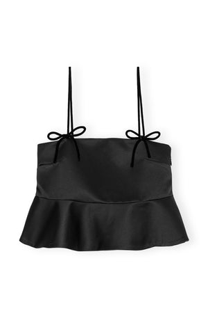 Black satin peplum tank top with bow detail on the strap.