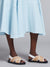Bottom half of model wearing the fussbett criss cross sandals with raffia effect fabric.