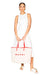 Model styled holding the janis medium tote in cream with red leather straps.