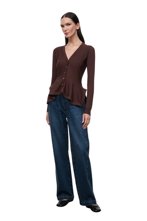 A woman modeling a dark brown long-sleeve button-front cardigan with a peplum hem, paired with dark blue wide-leg jeans and black shoes, against a plain white background.