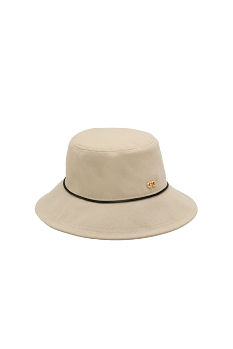 Beige bucket hat with black band on a light beige background